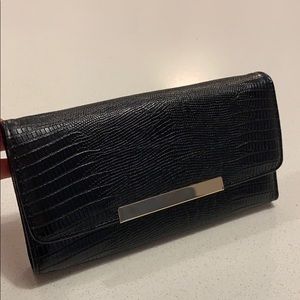 BCBG Black snake skinned clutch